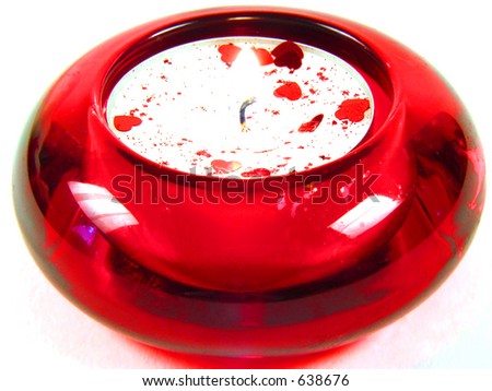 Red candle lying on white background with little hearts