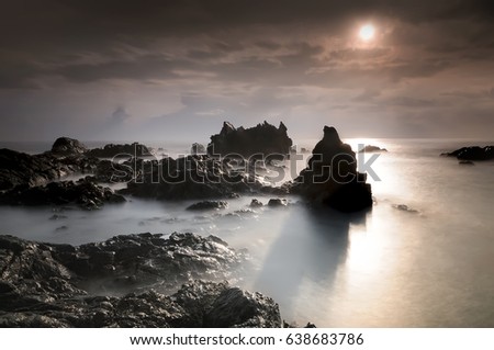 Tropical rocky beach at sunrise , located at Terengganu Malaysia.( long exposure photography,Soft focus due to long exposure shot. Nature composition )
