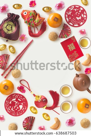 Chinese new year decorative item with "prosperity"  wording and food on white background. Flat lay text space image. Royalty-Free Stock Photo #638687503