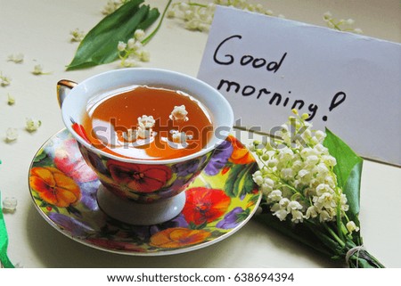 tea and lilies of the valley , inscription Good morning