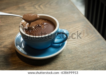 Blue Cups of hot Chocolate drink on dark wooden background. Morning time. Holiday concept, Selective focus