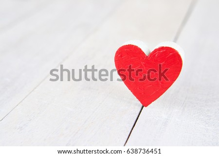 Red heart on a white wooden background
