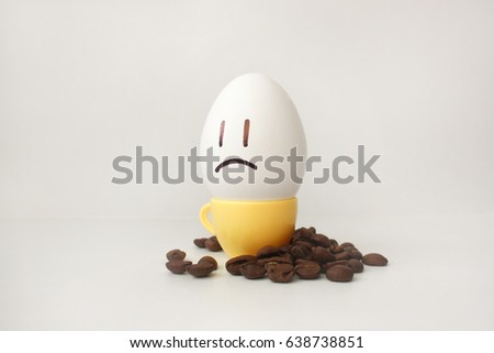 Egg with a face. Funny and cute to a coffee mug with coffee beans around. Useful and invigorating breakfast. Photo for your design. sleepy. Did not wake up