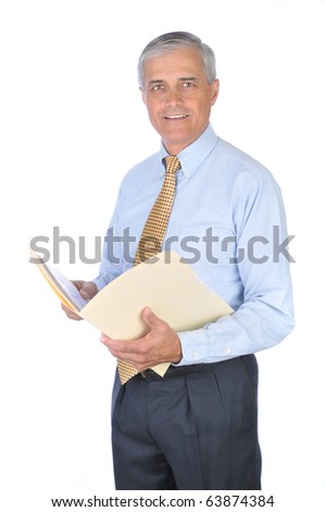 Middle aged businessman standing and holding a manila file folder. Vertical format isolated on white background.