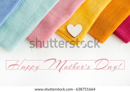 Happy Mother's Day Card, colorful textile and a Wooden Heart on White Background. Holiday Gift 