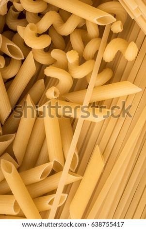 Types of raw pasta on the wooden table