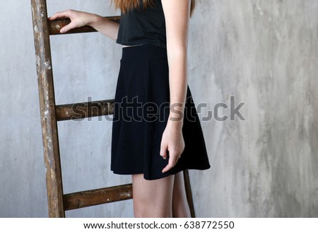 Young woman is climbing up on the ladder. Close-up

