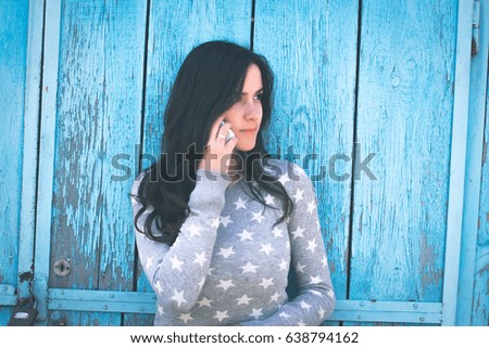 Beautiful girl on a background of blue wooden boards