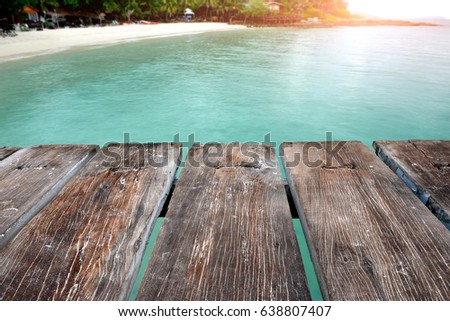 Sea wooden relax bridge in the morning time photo in the early of the morning with sunrise dark and  lowlight under cloudy lighting.