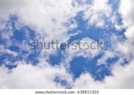 Heavenly space of blue color with a lot of thick white clouds. Background picture of a cloudy sky showing favorable weather