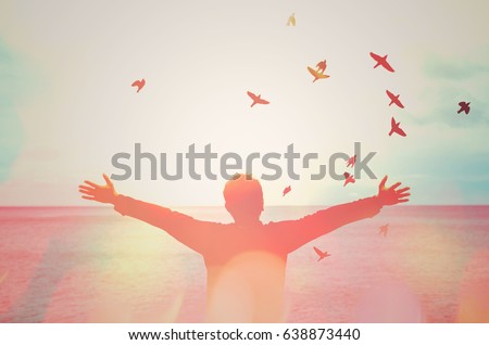 man hand rising and birds flying double exposure with colorful bokeh light on beach abstract texture background feel good and freedom travel adventure concept vintage tone color style Royalty-Free Stock Photo #638873440