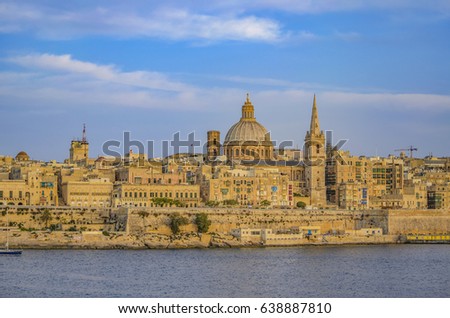 Valletta skyline panorama at sunset with the Carmelite Church dome and St. Pauls Anglican Cathedral, Valletta, Malta