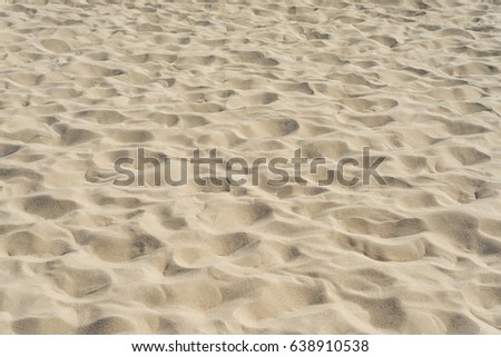 sand on the beach as background. soft focus in center of picture