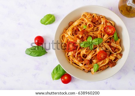 Pasta Fettuccine Bolognese with tomato sauce in white bowl. Flat lay. Top view Royalty-Free Stock Photo #638960200