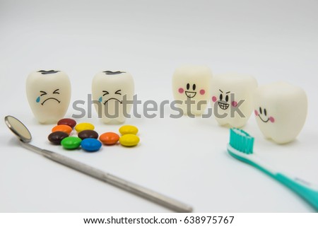 Model Cute toys teeth and colorful candy in dentistry on a white background.