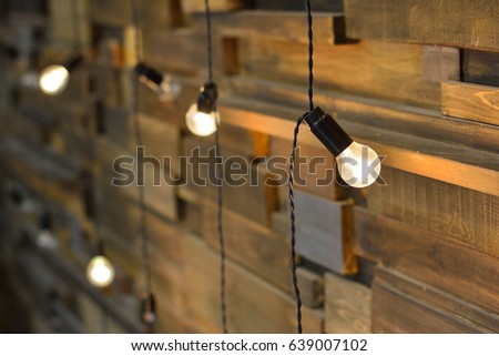 set of glowing light bulbs on wooden background isolated