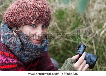Female photographer sitting outside.