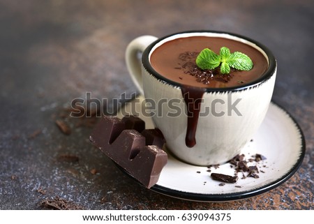 Portion of homemade mint hot chocolate in a cup on a dark slate,stone or metal background. Royalty-Free Stock Photo #639094375