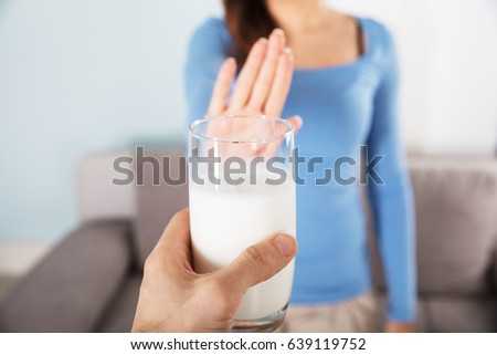 Close-up Of A Woman Rejecting Glass Of Milk At Home Royalty-Free Stock Photo #639119752