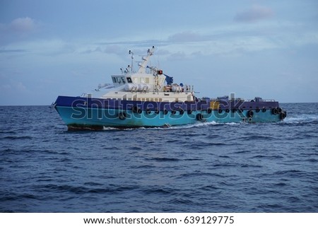 Fast crew boat sailing from offshore platform during crews change at South China Sea, Malaysia. Royalty-Free Stock Photo #639129775