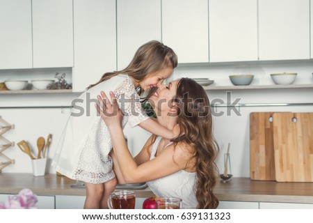 Mom and daughter in the kitchen. Royalty-Free Stock Photo #639131323