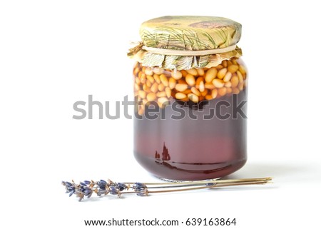 Jar of honey with pine nuts