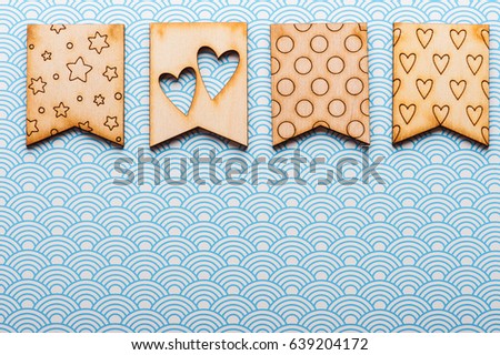 Wooden flags with hearts and stars on blue waves background. Greeting card concept