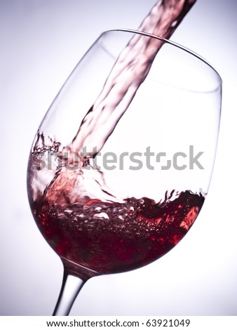 Pouring red wine in a glass