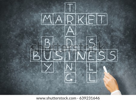 Business concept with crossword drawn with chalk on blackboard