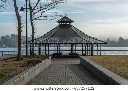 Fishing pavilion at the end of a public path on Pier A in Hoboken along the Hudson River in the early morning.