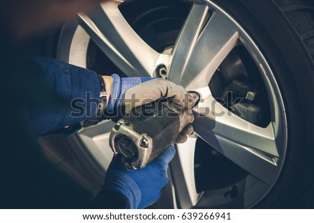Winter Tires Replacement and Rotation in the Car Service. Vehicle Seasonal Maintenance. Royalty-Free Stock Photo #639266941