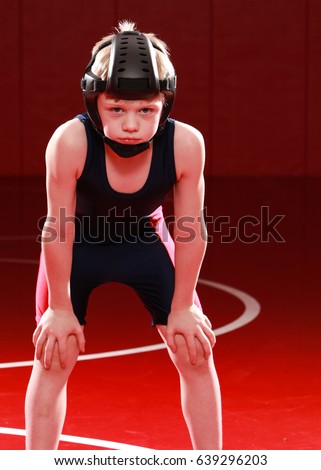 Youth wrestler with hands on knees