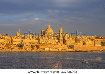 Valletta skyline panorama at sunset with the Carmelite Church dome and St. Pauls Anglican Cathedral. It is part of the UNESCO World Heritage Site. Valletta, Malta