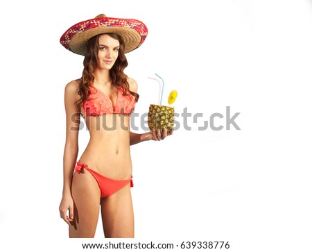 young adult brunette smiling girl in bikini in sombrero with exotic tropic cocktail isolated on white background
