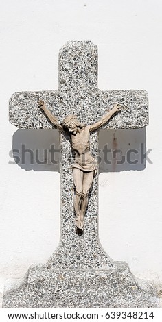 This is a photo of a cross in a public graveyard. 