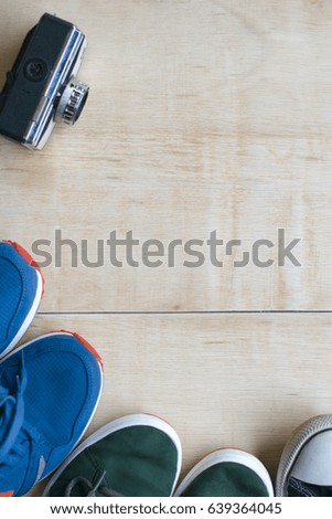 sneakers fitness concept, camera beside, wooden background