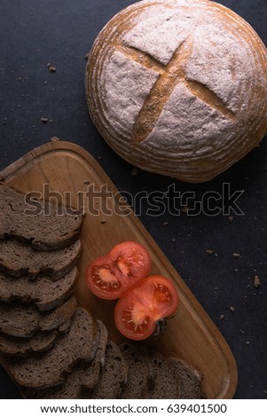 fresh tomatoes with homemade bread, lying on the kitchen wooden Board
