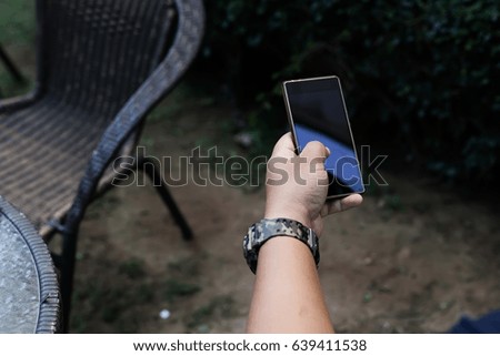 Man touching phone mobile screen in the coffee shop