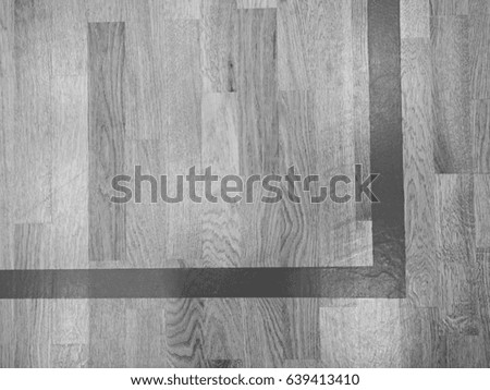 Corner line. Worn out wooden floor of sports hall with marking lines. Black and white photograph.