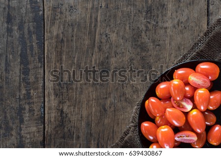 top view Close-up Fresh Tomatoes put in dish on Wood Background