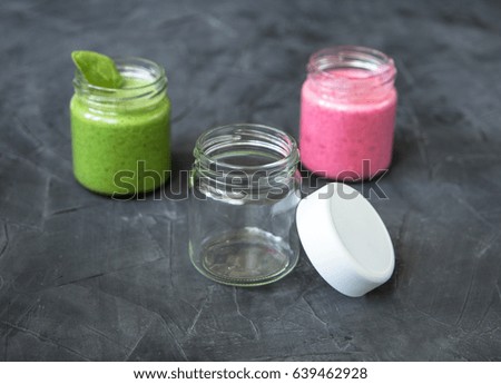 fresh smoothie variations in jars ans an empty jar. concept of choice