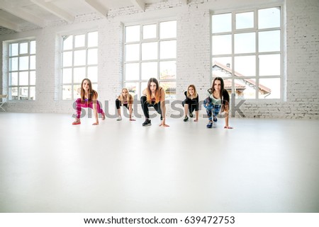 Many girls doing exercises in the gym. Fitness. The concept of sport, dance and a healthy lifestyle.