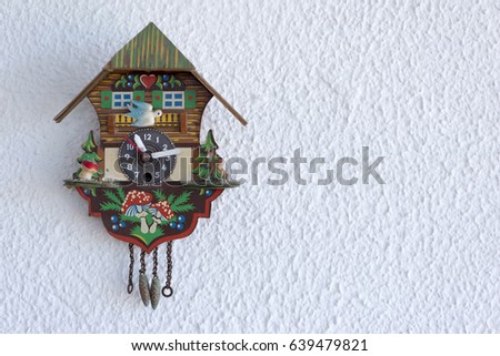 A cuckoo clock hanging on the wall Royalty-Free Stock Photo #639479821