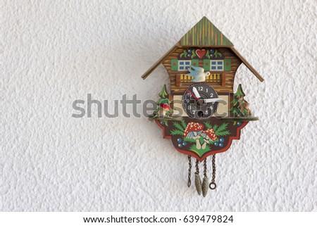 A cuckoo clock hanging on the wall Royalty-Free Stock Photo #639479824