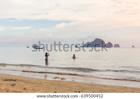 Young women traveler with two pieces at sea take a photo from Ao Nang Beach Krabi. Traveling in Krabi Thailand, Traveler summer concept
