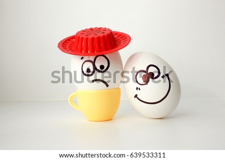 An egg with a face. Funny and sweet. SAD IN THE HAT. AMIGO. LOVE IS SAD AND FRIEND MERRY. FRIENDSHIP SURPRISES. Photo for your design.
