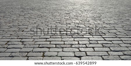 Abstract background of old cobblestone pavement close-up. Royalty-Free Stock Photo #639542899