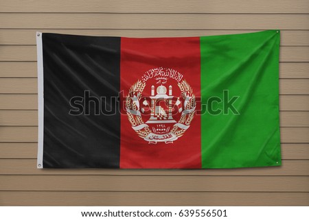 Flag of Afghanistan haning on a wall