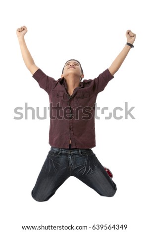 Happy and excited young asian man jumping and waving his arms gesturing success; isolated on white background