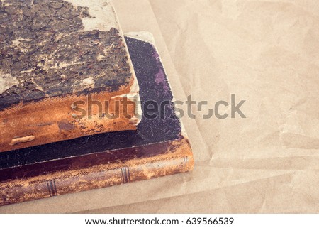 Very old books on the packing paper background. Close up.